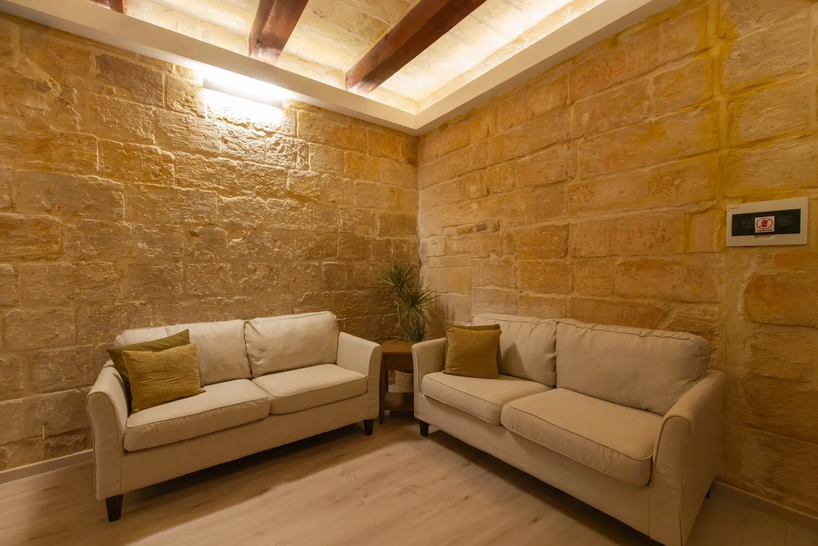 Two sofas against the original limestone walls