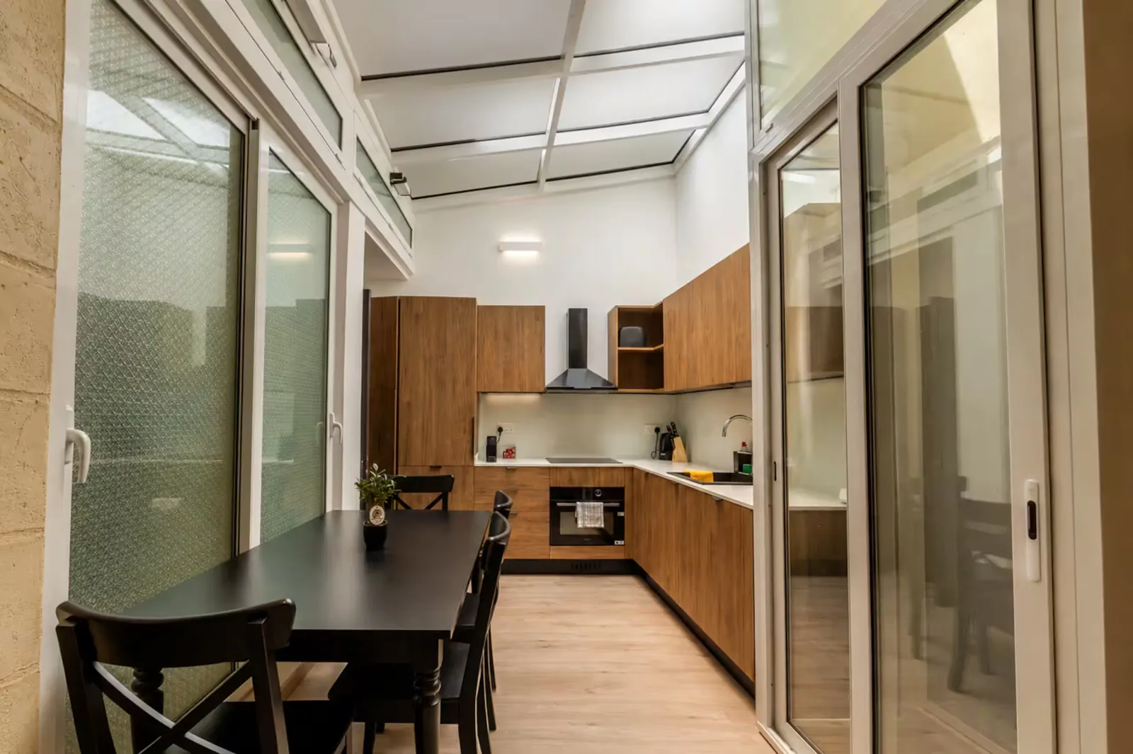 Glass-roofed kitchen and dining table
