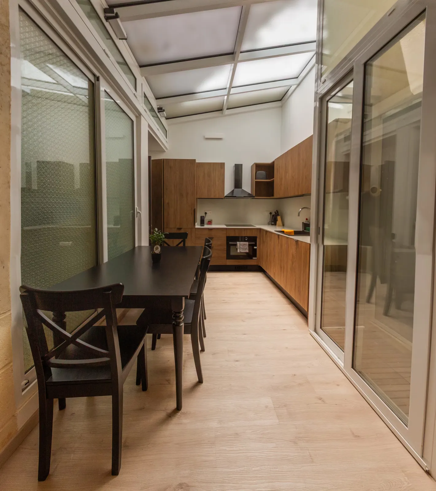 Dining table and fitted wooden kitchen