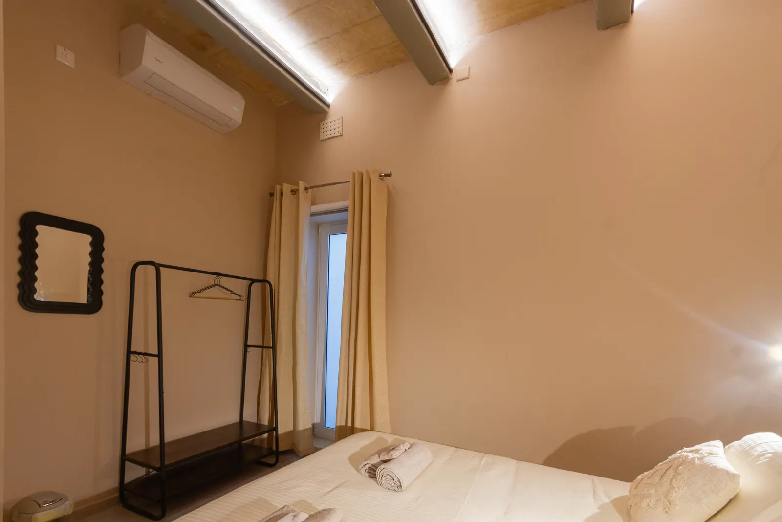 Bedroom with clothes rail and window
