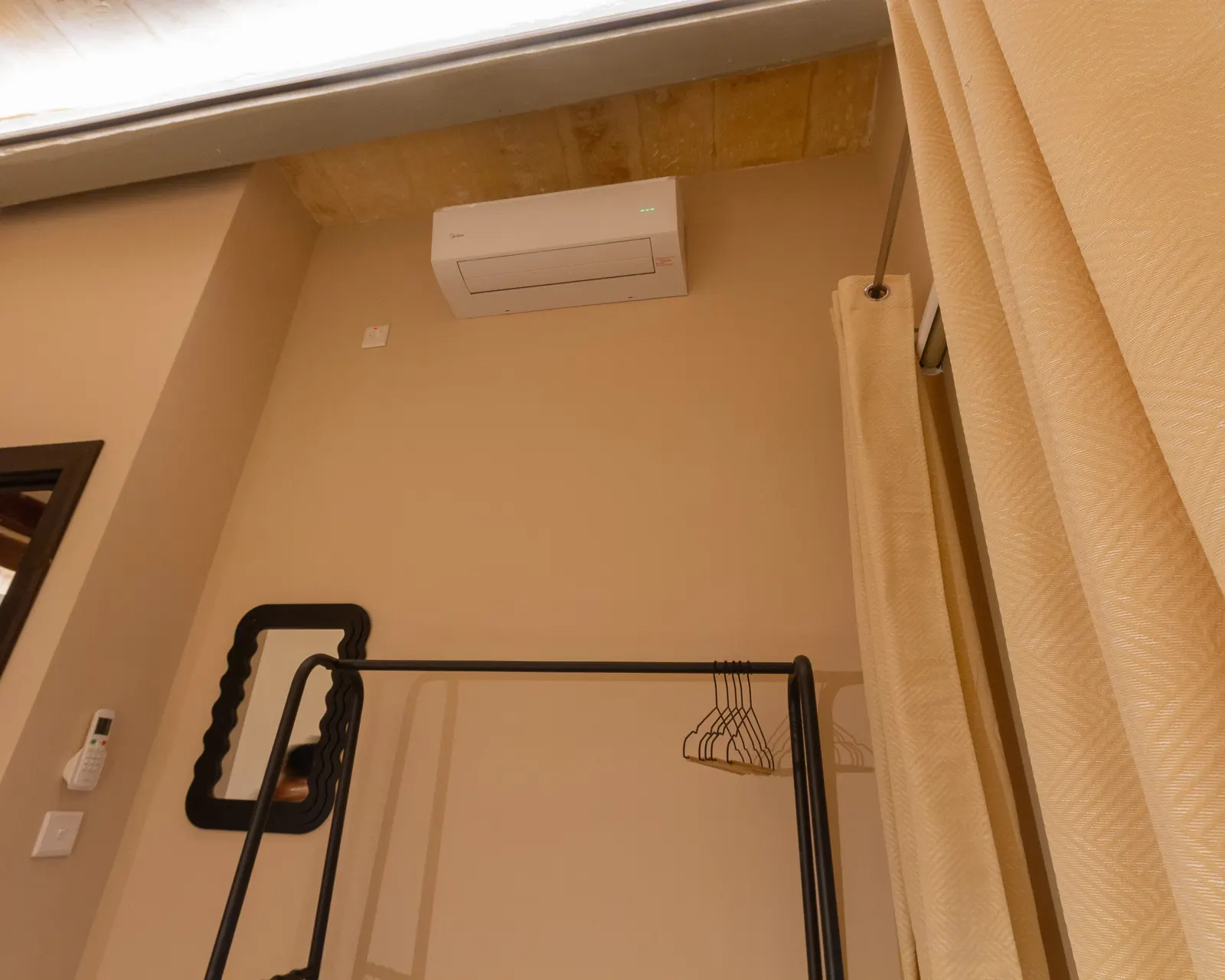 Air-conditioned bedroom with clothes rail