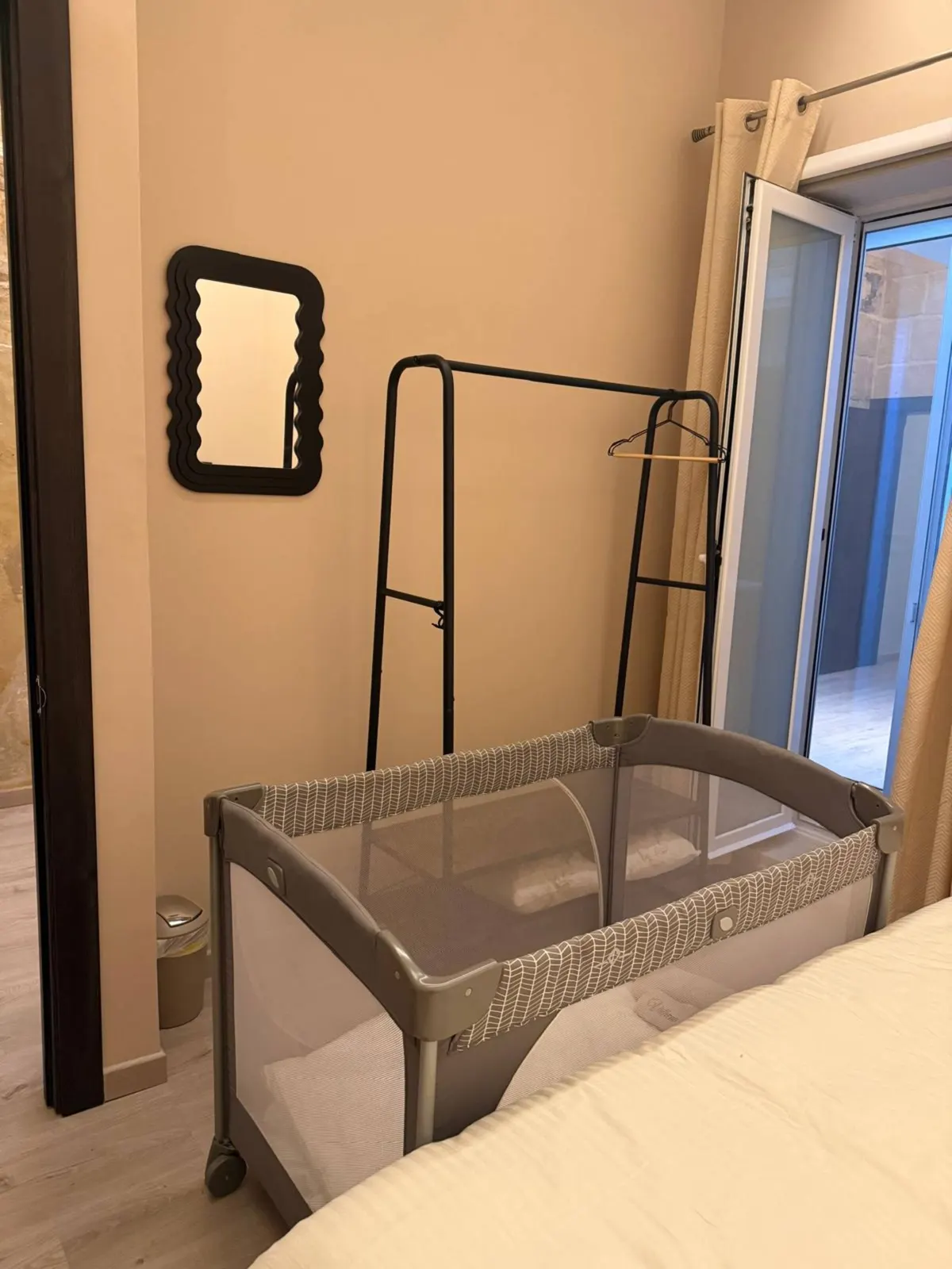 Bedroom with travel cot set up